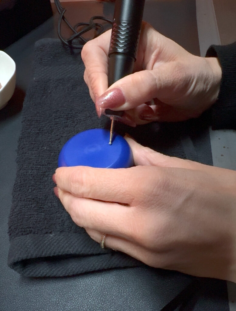 Professional hand engraver getting ready to engrave a plastic yo-yo at a brand activation.