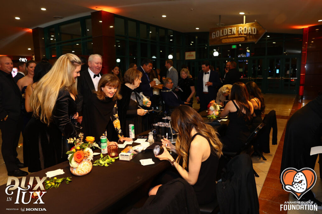 Dux in Tux charity event with guests lining up to get their items personalized with professional engraving services